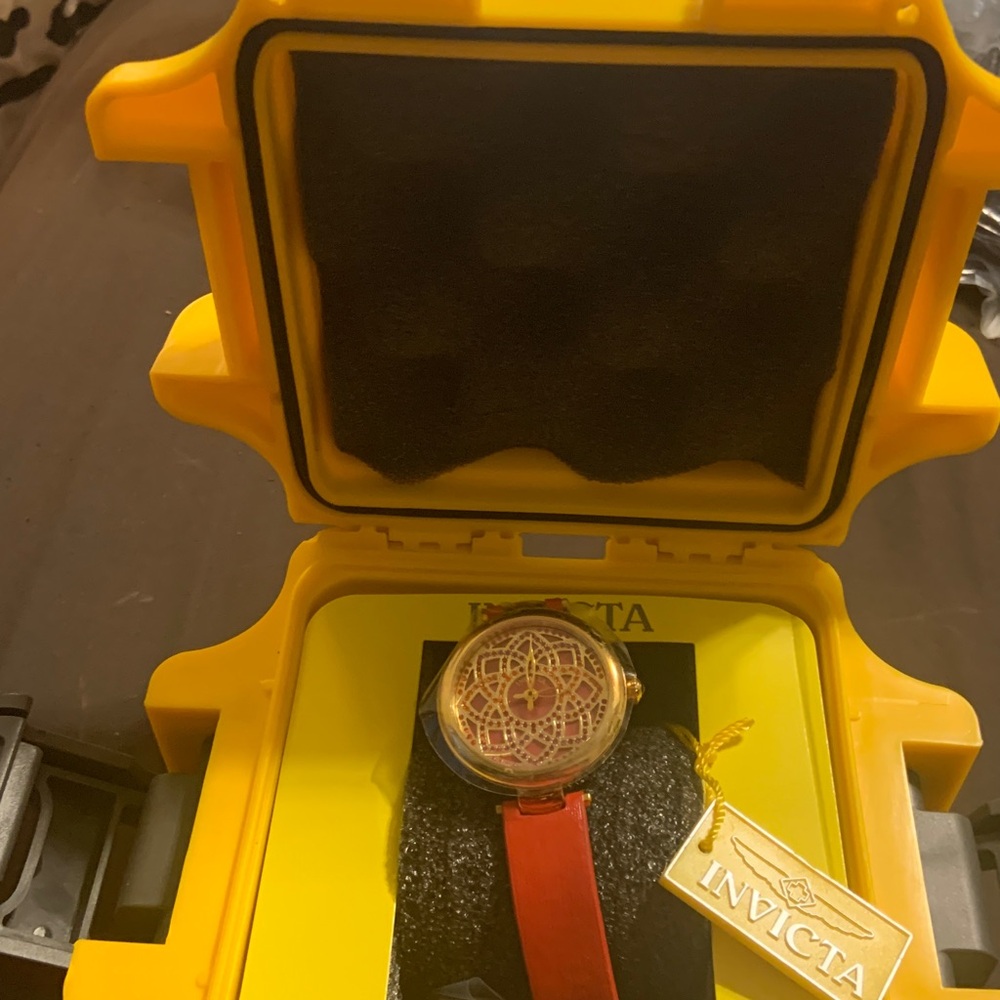 Invicta watch  red leather band
Face has a daisy style print
The case is yellow